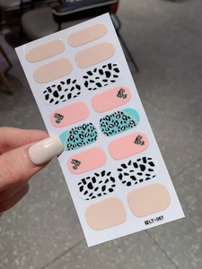 Detail shot of heart pattern nail art stickers with cow print and leopard textures