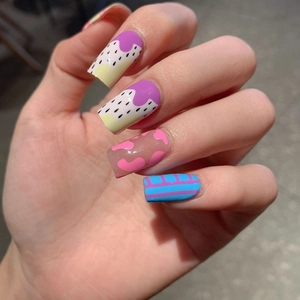 Long square colorful nail wraps featuring purple swirls, polka dots, and heart patterns