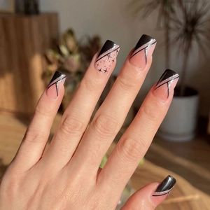 Minimalist long coffin press-on nails with black French tips and silver glitter star accents