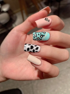 Detailed view of long square press-on nails with mixed animal prints and glossy finish
