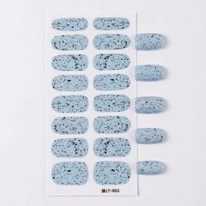 Light blue minimalist nail polish stickers with black ink splatters on white board