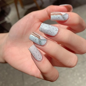 Short square blue marble nail wraps with artistic dark spots and wavy gradient patterns