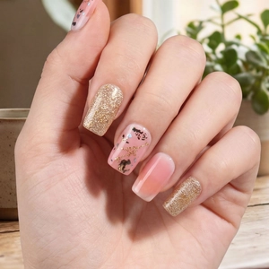Chic gold glitter and pink foil press-on nails with abstract black speckle patterns