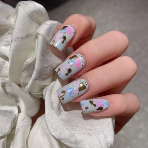 Chic light grey press-on nails with colorful doodle art and elegant gold foil accents