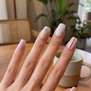 Minimalist waterproof nail stickers featuring pink and beige wave patterns and black polka dots