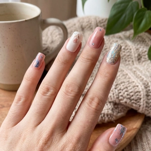 Floral spring nail patches with pink glitter, rose art and rhinestones on hands