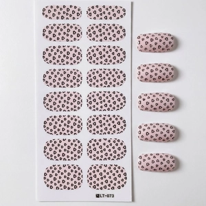 Minimalist nail stickers with pink base and black heart pattern with application view
