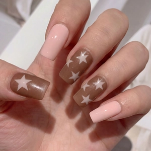Brown and pink square nails with white star designs on long glossy press-on nails