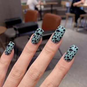 Mint green leopard print nail stickers with long square shape on manicured hands