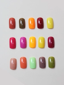 Flat lay of 15 colorful square round glossy press-on nails in various saturated tones