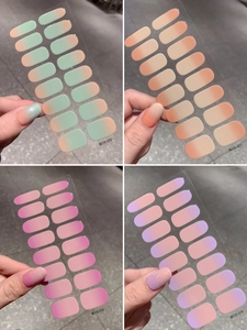 Macro detail of four gradient nail wrap sets including pink, orange, and purple color options