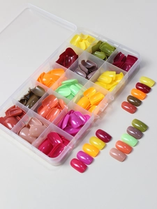 Close-up of vibrant multi-color fake nail set in a 24-compartment clear storage organizer
