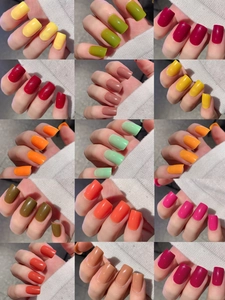 Close-up of 15 solid color short press-on nails set with glossy finish for manicure styles