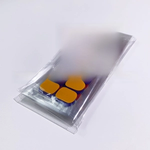Detail view of glitter adhesive nail polish wraps in orange and blue with model tags