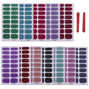 Set of 12 glitter nail polish wraps in assorted colors with nail files on white background