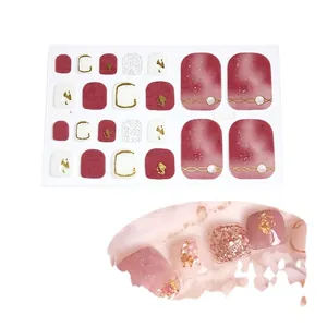 5D red and white toe nail wraps with glitter, gold accents and pearl decorations