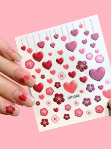Macro shot of DP1346 nail stickers with red hearts and flowers on professional manicure