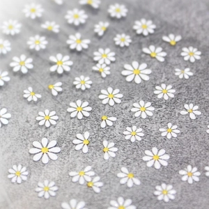 3D embossed white daisy nail art stickers with delicate yellow centers on stone