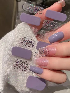 Detail von hauchdünnen lila matten und Glitzer-Nagelstickern auf Pullover-Hintergrund