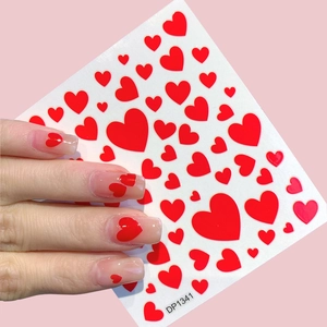 Red heart nail stickers with various heart patterns on long transparent nails, model DP1341