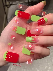 Detail shot of strawberry nail stickers with red dots and white flowers on clear film