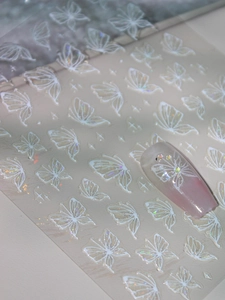 Detailed holographic butterfly nail art stickers with white 3D relief and shimmering stars