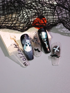 Detail view of Halloween nail art stickers with skulls, bats and Gothic matte finish