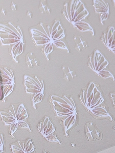 Macro detail of 3D embossed butterfly nail art stickers with laser holographic finish