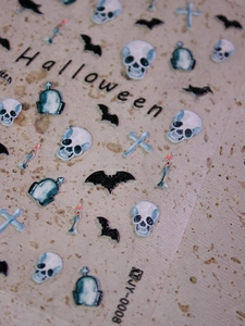 Macro shot of Halloween nail stickers with bats and skulls in a matte pearlescent finish