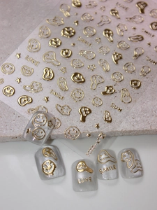 Detail of 3D gold embossed nail stickers with melting smiley face and star patterns