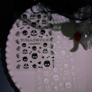 3D matte Halloween nail stickers featuring skulls and pumpkins on a decorative tray