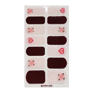 Glittery burgundy and pink nail wraps with heart and star patterns in 14-piece set