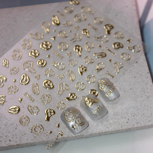 Gold metallic 3D nail stickers featuring melted smileys and celestial star patterns