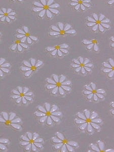 Close-up of 5D white daisy nail art stickers with embossed petals and yellow centers