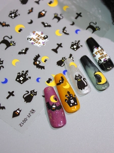 Detail of Halloween nail stickers with matte black cat and moon patterns on diverse nails