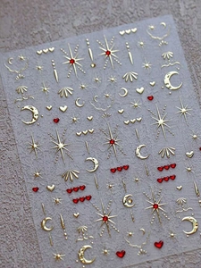 Detailed view of gold moon and star nail stickers with 3D red heart jelly accents