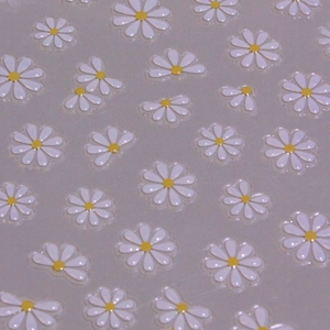 3D white daisy nail art stickers with yellow centers and embossed texture for DIY decor