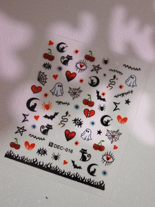 Macro shot of Halloween nail stickers featuring bats, moons and ghosts on DEC-016 sheet