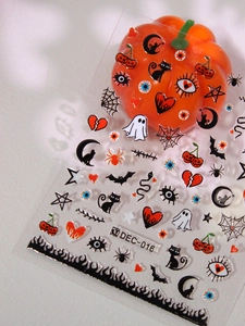 Halloween nail art stickers with ghosts and bats motifs on a decorative white surface
