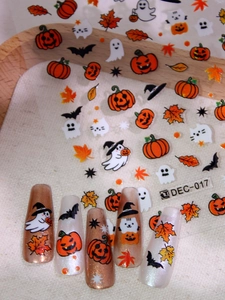 Detailed view of Halloween nail art stickers with pumpkin and ghost designs for DIY manicure