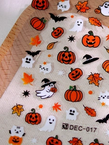 Detail of Halloween nail stickers featuring pumpkins, ghosts and bats on transparent film