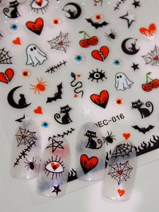 Macro view of Halloween nail art stickers with black cat, spider web, and ghost patterns