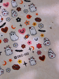 Macro detail of Halloween nail stickers featuring ghosts, pumpkins and bats on sheet DEC-022