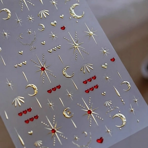 3D gold embossed nail stickers with stars, moons and hearts on transparent backing