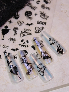 Detail of Halloween nail decals with black pumpkin, bat, and spider silhouettes