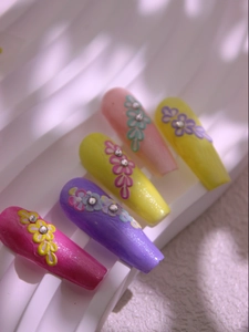 Close-up of 5D floral nail stickers with relief patterns and rhinestones on coffin nails