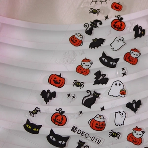 Halloween nail stickers with pumpkins, black cats, and ghost patterns on white background