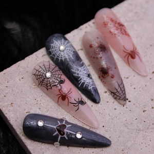 Halloween almond false nails featuring spider webs, blood splatters, and crystal heart gems