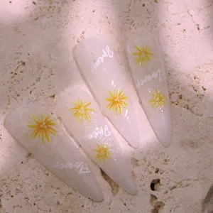5D embossed yellow daisy nail art stickers on translucent almond press-on nails