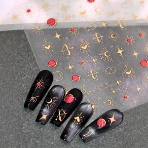 3D gold and red celestial nail stickers featuring moon, star, and planet patterns